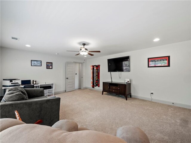 living room featuring light colored carpet and ceiling fan