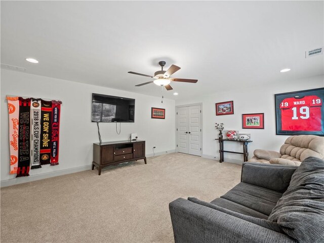 living room featuring light colored carpet and ceiling fan