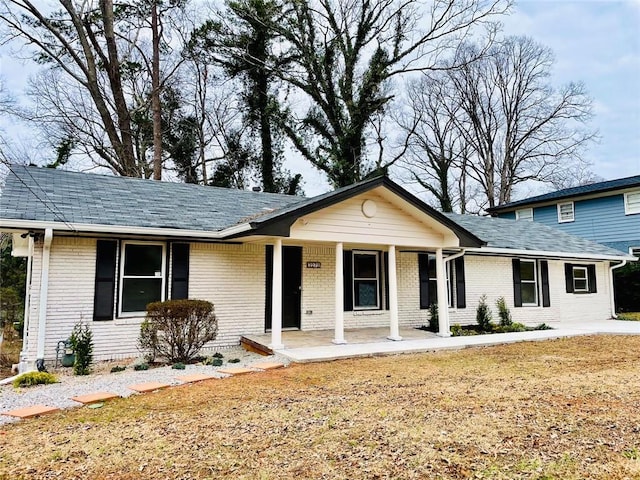 view of front of property with covered porch and brick siding