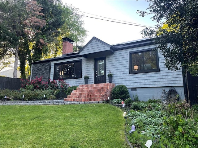 view of front of house featuring a front lawn and a chimney