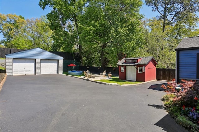 detached garage featuring fence