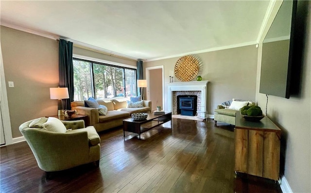 living area featuring dark wood-type flooring, a glass covered fireplace, crown molding, and baseboards
