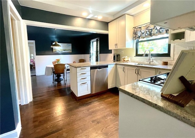 kitchen with stainless steel dishwasher, a sink, white cabinetry, a peninsula, and dark wood-type flooring