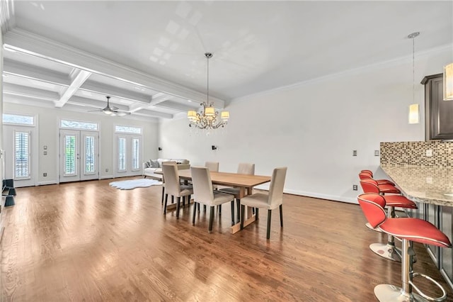 dining area with beam ceiling, coffered ceiling, hardwood / wood-style flooring, ceiling fan with notable chandelier, and ornamental molding