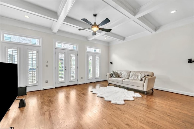 living room featuring coffered ceiling, french doors, hardwood / wood-style flooring, ceiling fan, and beam ceiling