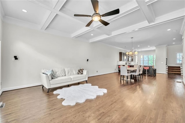 living room with beam ceiling, coffered ceiling, crown molding, hardwood / wood-style floors, and ceiling fan with notable chandelier