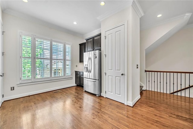 kitchen featuring stainless steel fridge with ice dispenser, ornamental molding, and wood-type flooring