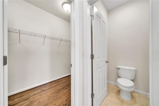 bathroom featuring hardwood / wood-style floors and toilet