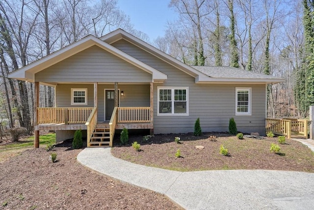 view of front of property featuring roof with shingles and covered porch