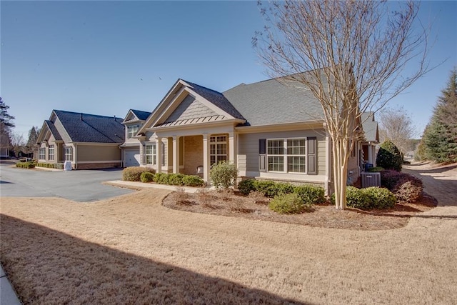 view of front of home with central AC unit and a garage