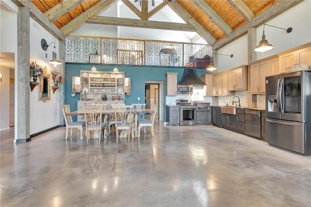 kitchen featuring beam ceiling, wooden ceiling, light brown cabinetry, stainless steel appliances, and concrete flooring