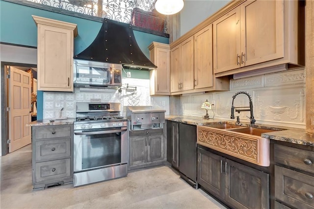 kitchen with appliances with stainless steel finishes, light stone counters, and tasteful backsplash