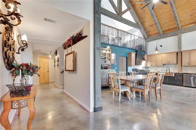 dining area with high vaulted ceiling, wooden ceiling, sink, and concrete flooring