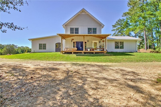 back of property with a porch and a lawn