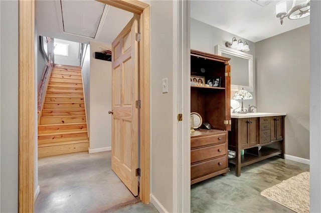 bathroom with vanity, wooden walls, and concrete flooring