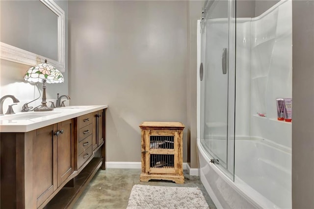 bathroom with vanity, enclosed tub / shower combo, and concrete floors