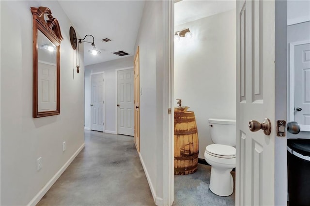 bathroom featuring toilet and concrete floors