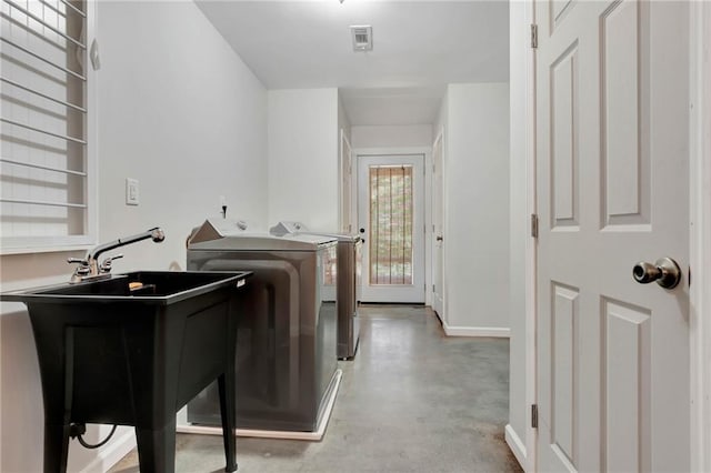 laundry area featuring sink and washing machine and clothes dryer