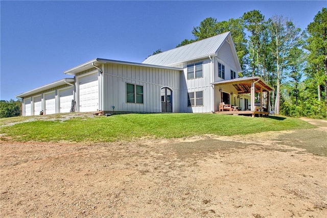 exterior space featuring a garage, a front lawn, and a porch