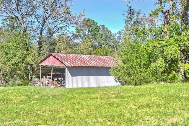 view of outbuilding with a yard