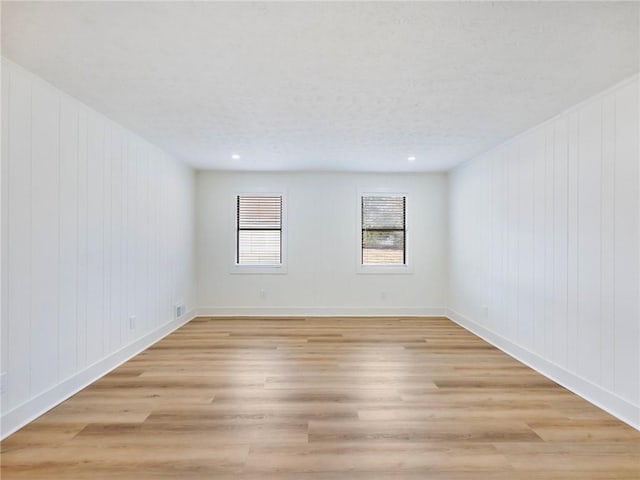 empty room featuring light hardwood / wood-style floors and a textured ceiling