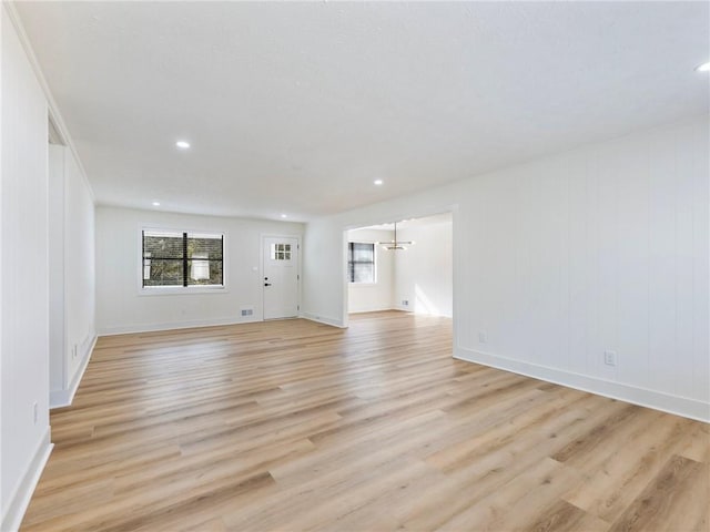 unfurnished living room with a healthy amount of sunlight and light wood-type flooring