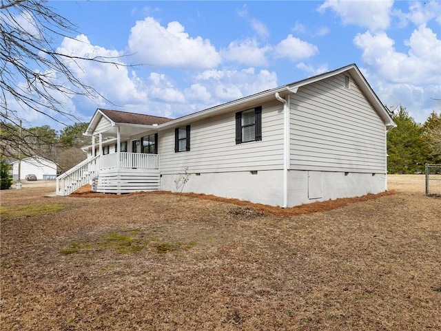 view of side of property featuring a porch