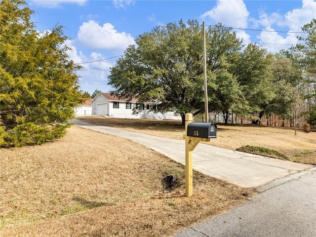 view of property hidden behind natural elements featuring a garage