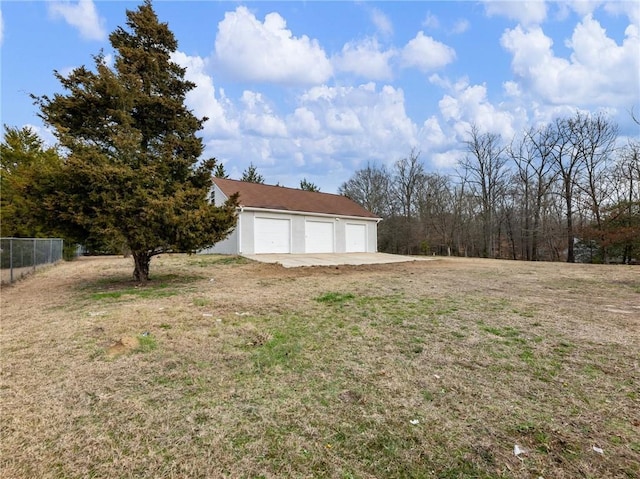 view of yard with a garage and an outdoor structure