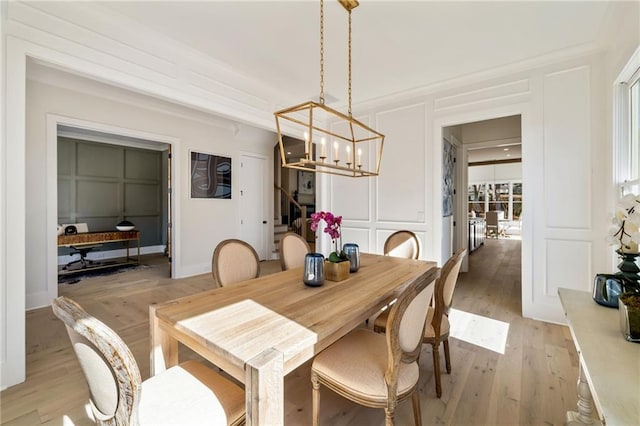 dining room featuring an inviting chandelier and light wood-type flooring