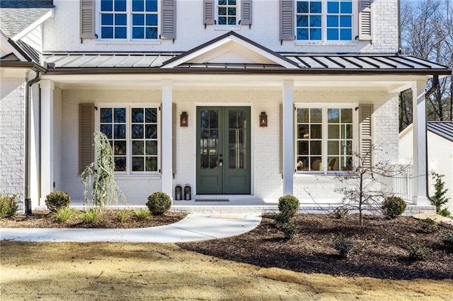 view of exterior entry featuring french doors