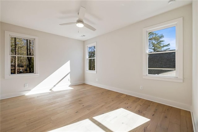 empty room featuring ceiling fan and light hardwood / wood-style flooring