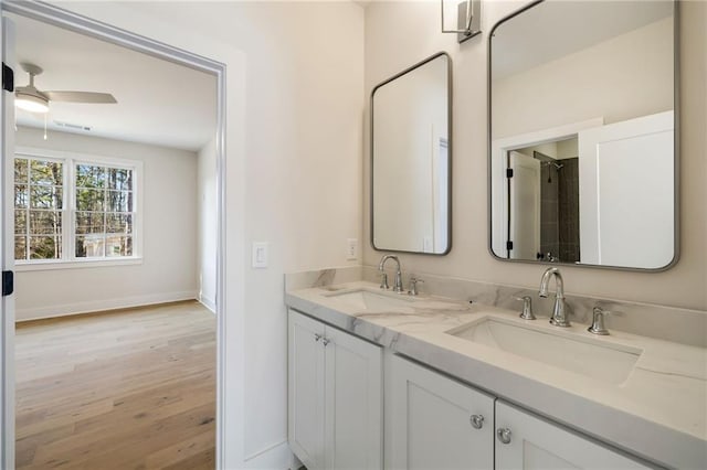 bathroom with vanity, hardwood / wood-style floors, and ceiling fan