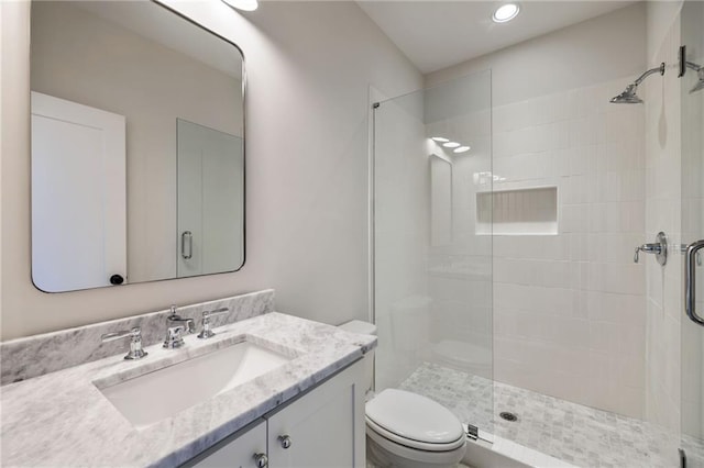 bathroom with vanity, toilet, and an enclosed shower