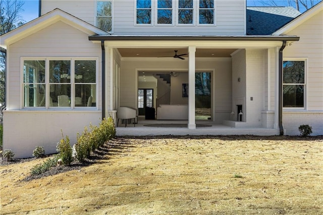 back of property featuring ceiling fan and a patio area