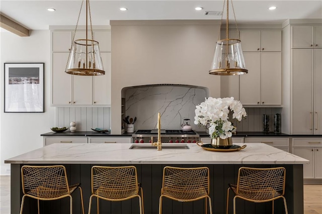 kitchen with dark stone countertops, decorative backsplash, and a spacious island