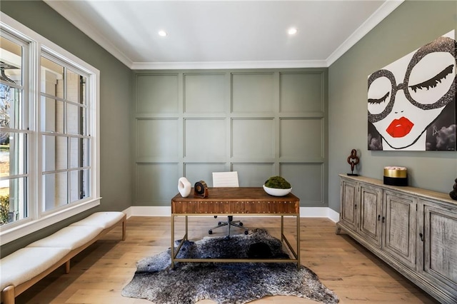 home office with crown molding and light hardwood / wood-style flooring