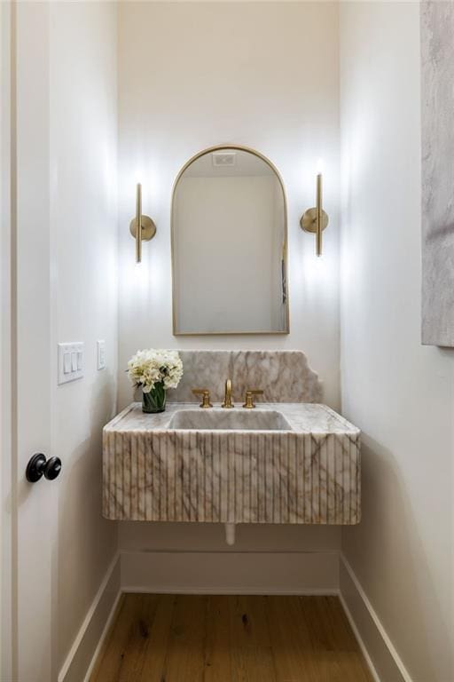 bathroom with sink and hardwood / wood-style floors