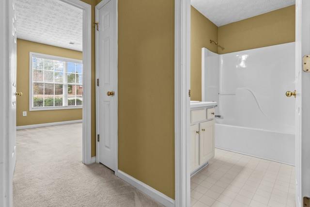 bathroom with vanity and washtub / shower combination