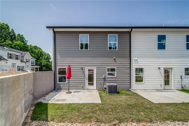 back of house with central AC, a yard, and a patio