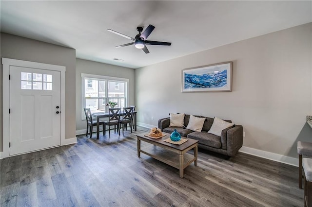 living room with dark hardwood / wood-style floors and ceiling fan