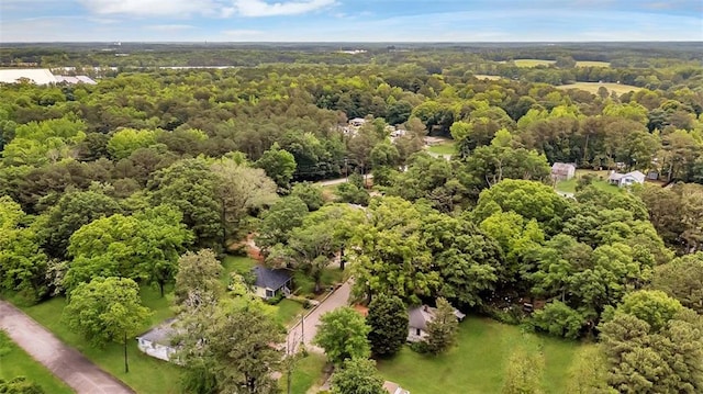 aerial view of property and surrounding area with a heavily wooded area