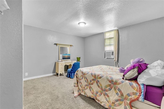 carpeted bedroom with a textured ceiling, a textured wall, cooling unit, and baseboards