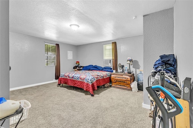 bedroom featuring carpet, a textured ceiling, a textured wall, and baseboards