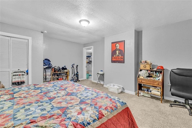 bedroom with carpet, a textured ceiling, a closet, and baseboards