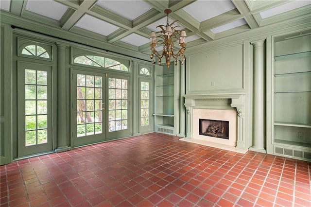 401 Peachtree Battle Ave NW, Atlanta, GA 30305 - unfurnished living room featuring a chandelier, built in features, beam ceiling, plenty of natural light, and coffered ceiling