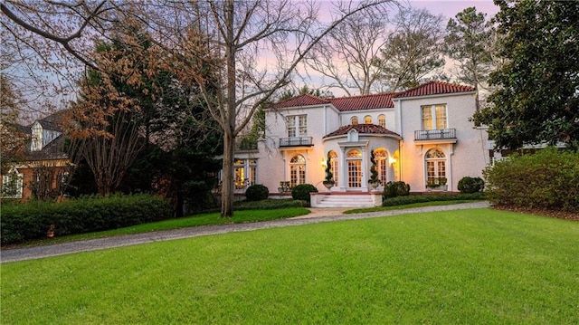 401 Peachtree Battle Ave NW, Atlanta, GA 30305 - mediterranean / spanish house featuring a tile roof, a yard, a balcony, french doors, and stucco siding