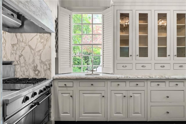 401 Peachtree Battle Ave NW, Atlanta, GA 30305 - kitchen with under cabinet range hood, high end stainless steel range oven, tasteful backsplash, and white cabinetry
