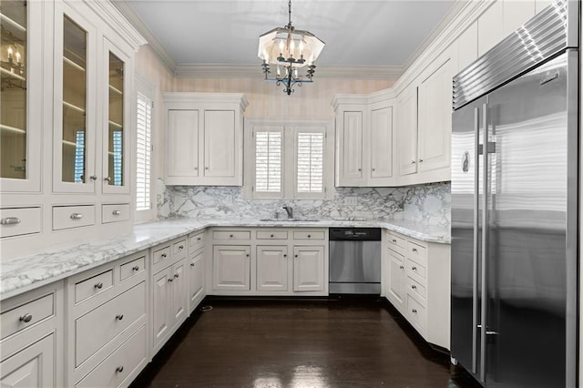 401 Peachtree Battle Ave NW, Atlanta, GA 30305 - kitchen featuring appliances with stainless steel finishes, a chandelier, white cabinets, decorative backsplash, and crown molding