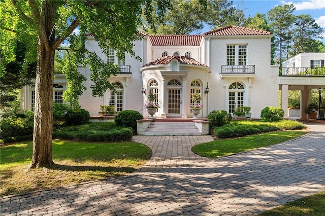 401 Peachtree Battle Ave NW, Atlanta, GA 30305 - mediterranean / spanish-style house featuring a balcony, a tiled roof, french doors, and stucco siding
